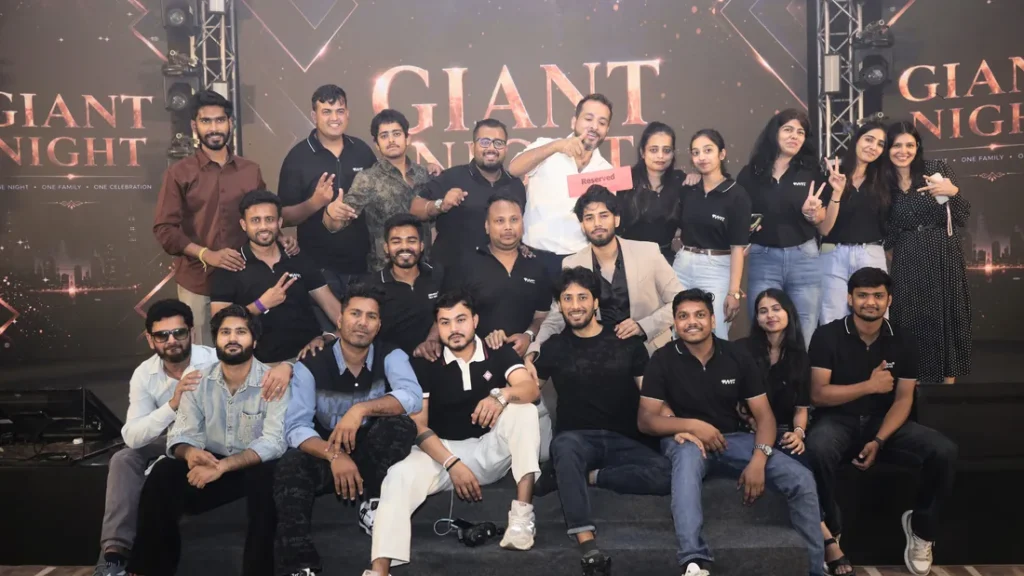 Group photo in front of the Giant Night backdrop